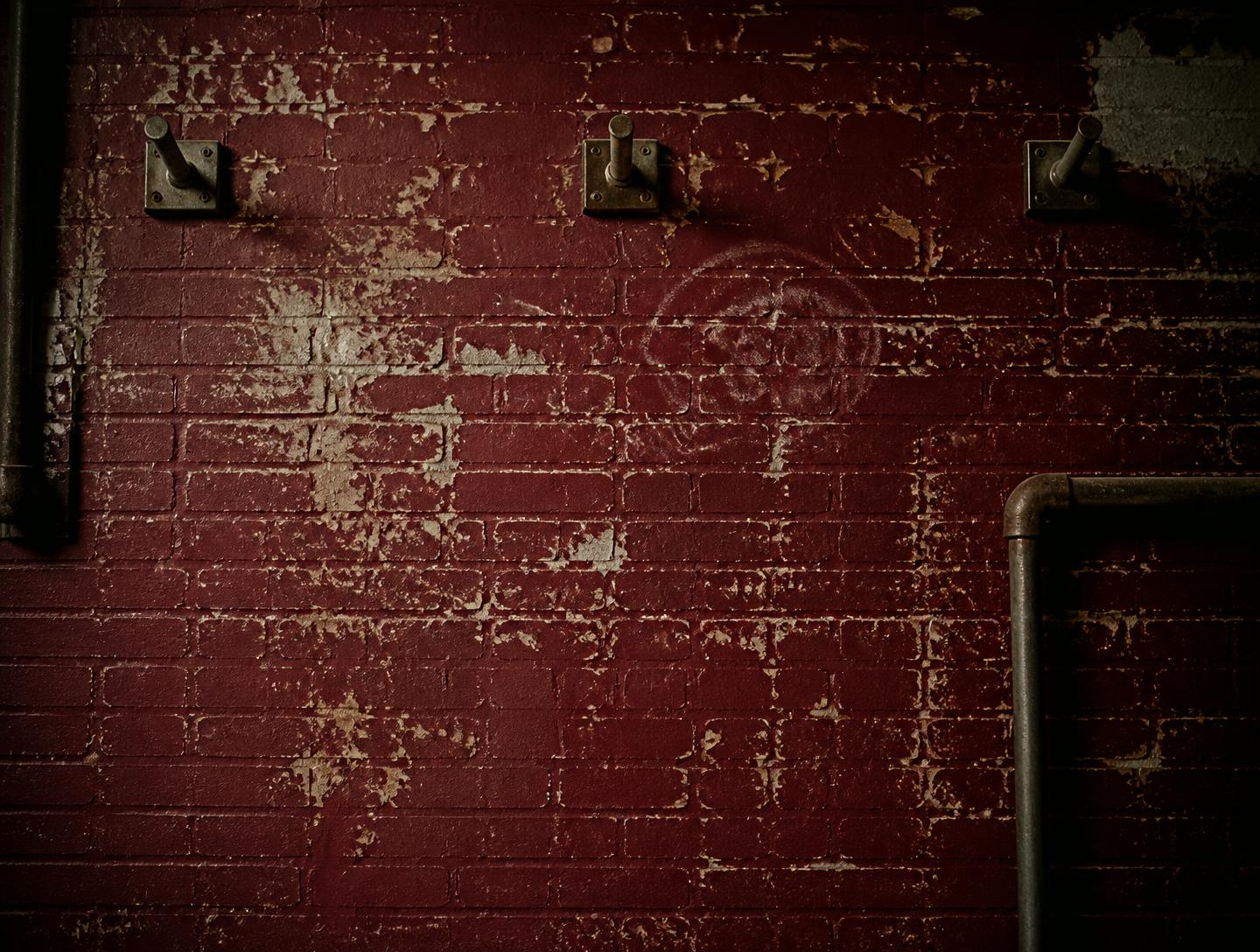 Weathered maroon brick gym wall